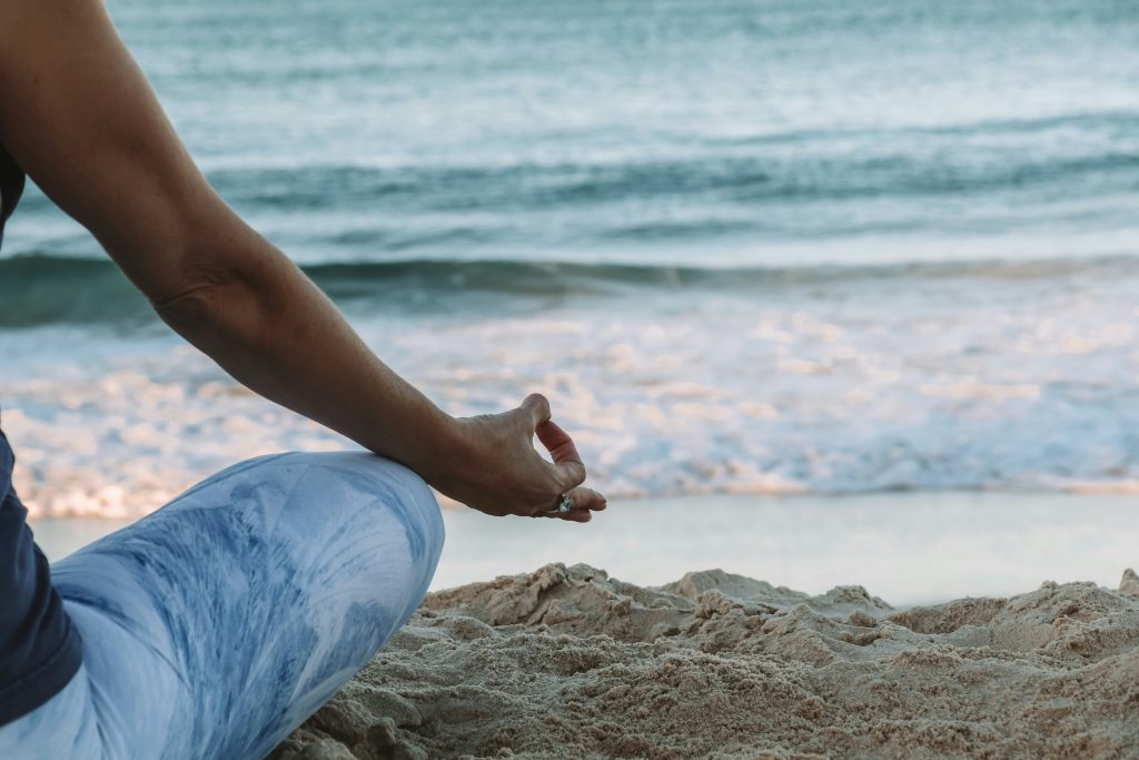 sitting and having yoga at the beach